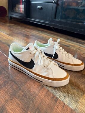 Nike Sneakers with Black Swoosh and Gold Accent